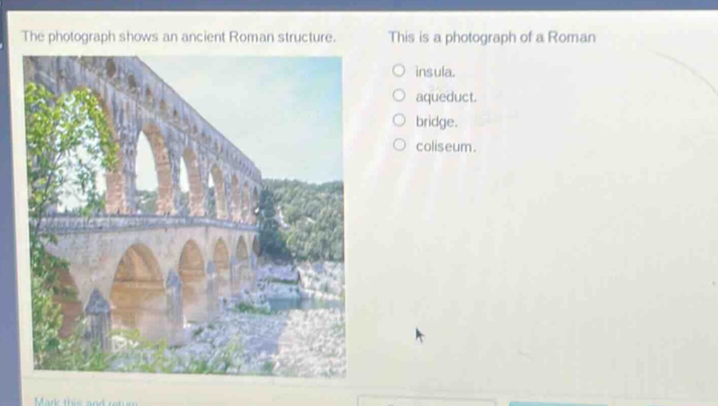 the photograph shows an ancient roman structure. this is a photograph of a roman insula. aqueduct. bridge. coliseum.