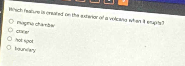 which feature is created on the exterior of a volcano when it erupts?\nmagma chamber\ncrater\nhot spot\nboundary