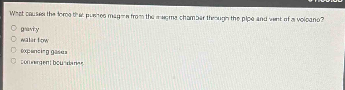 what causes the force that pushes magma from the magma chamber through the pipe and vent of a volcano?\n gravity\n water flow\n expanding gases\n convergent boundaries