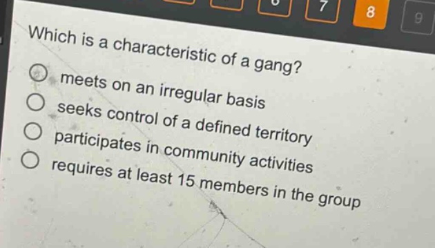 which is a characteristic of a gang?\nmeets on an irregular basis\nseeks control of a defined territory\nparticipates in community activities\nrequires at least 15 members in the group