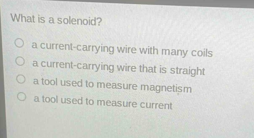 what is a solenoid?\n a current - carrying wire with many coils\n a current - carrying wire that is straight\n a tool used to measure magnetism\n a tool used to measure current