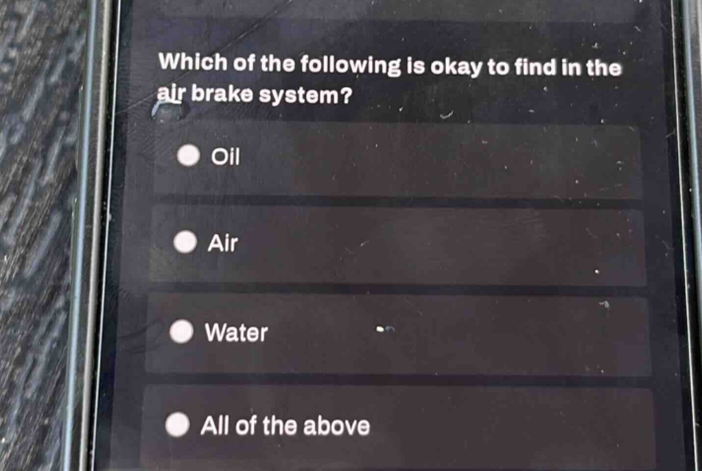 which of the following is okay to find in the air brake system?\noil\nair\nwater\nall of the above