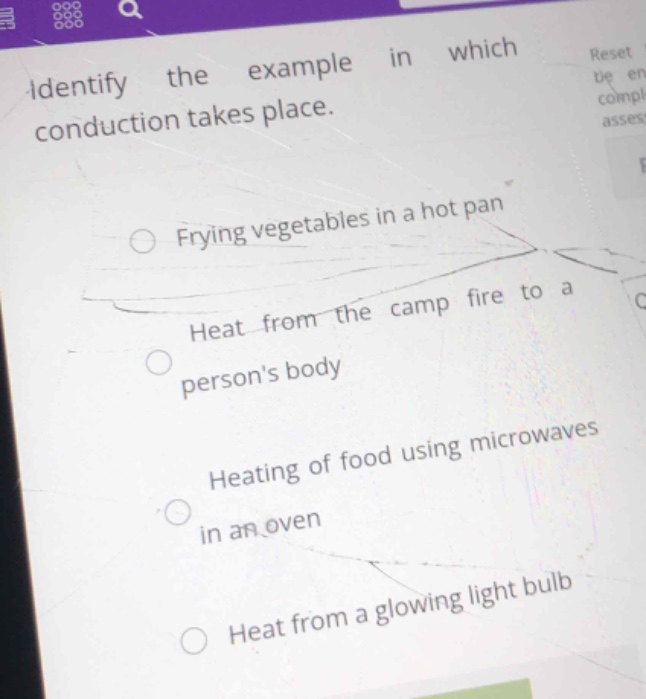 identify the example in which conduction takes place.\nfrying vegetables in a hot pan\nheat from the camp fire to a persons body\nheating of food using microwaves in an oven\nheat from a glowing light bulb