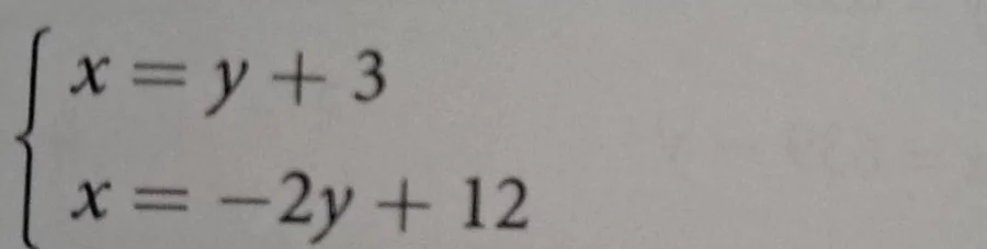 \\begin{cases} x = y + 3 \\\\ x = -2y + 12 \\end{cases}