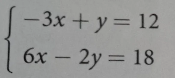 solve the system of equations \\(\\begin{cases} -3x + y = 12 \\\\ 6x - …
