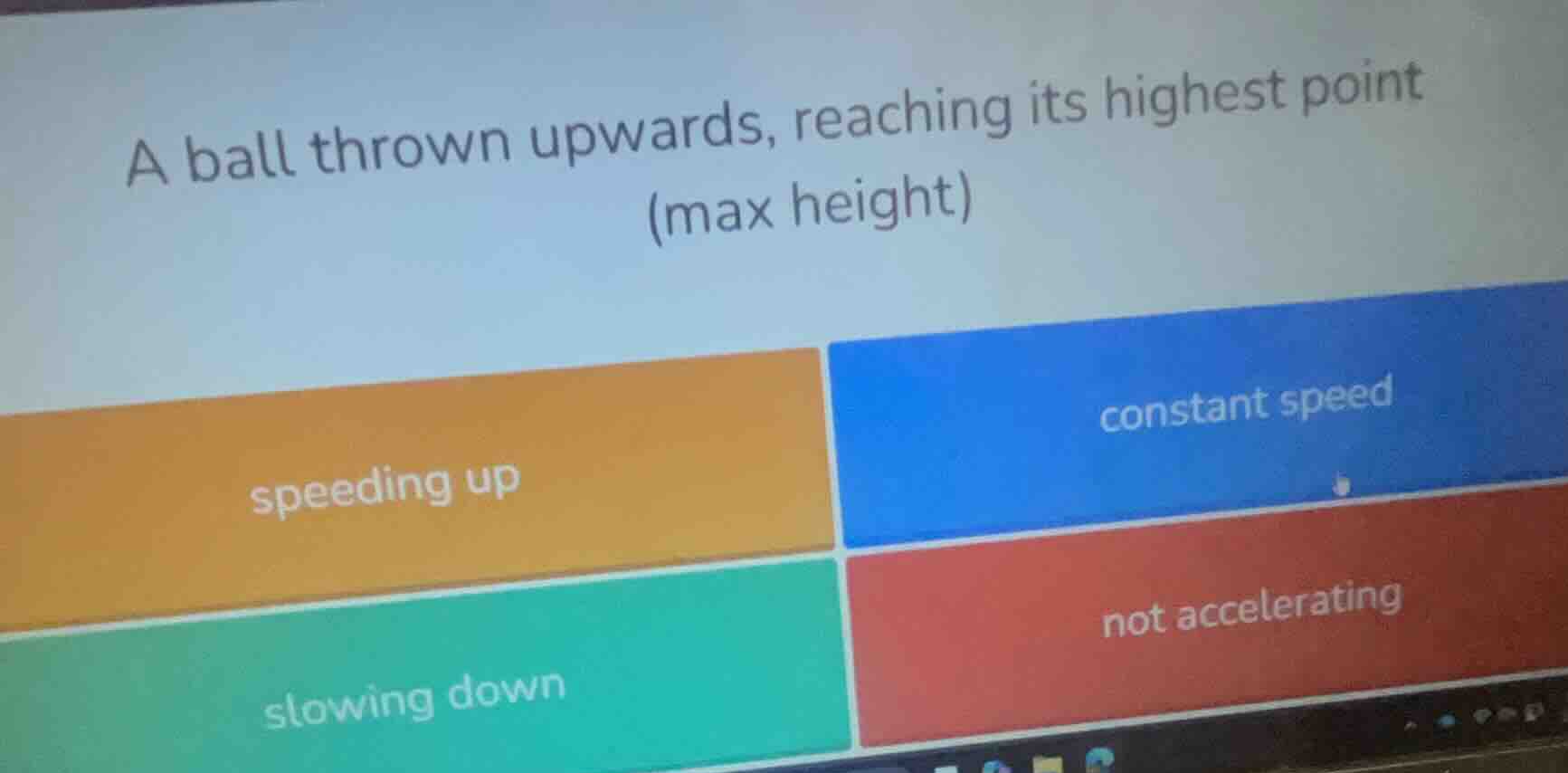 a ball thrown upwards, reaching its highest point (max height) speeding…