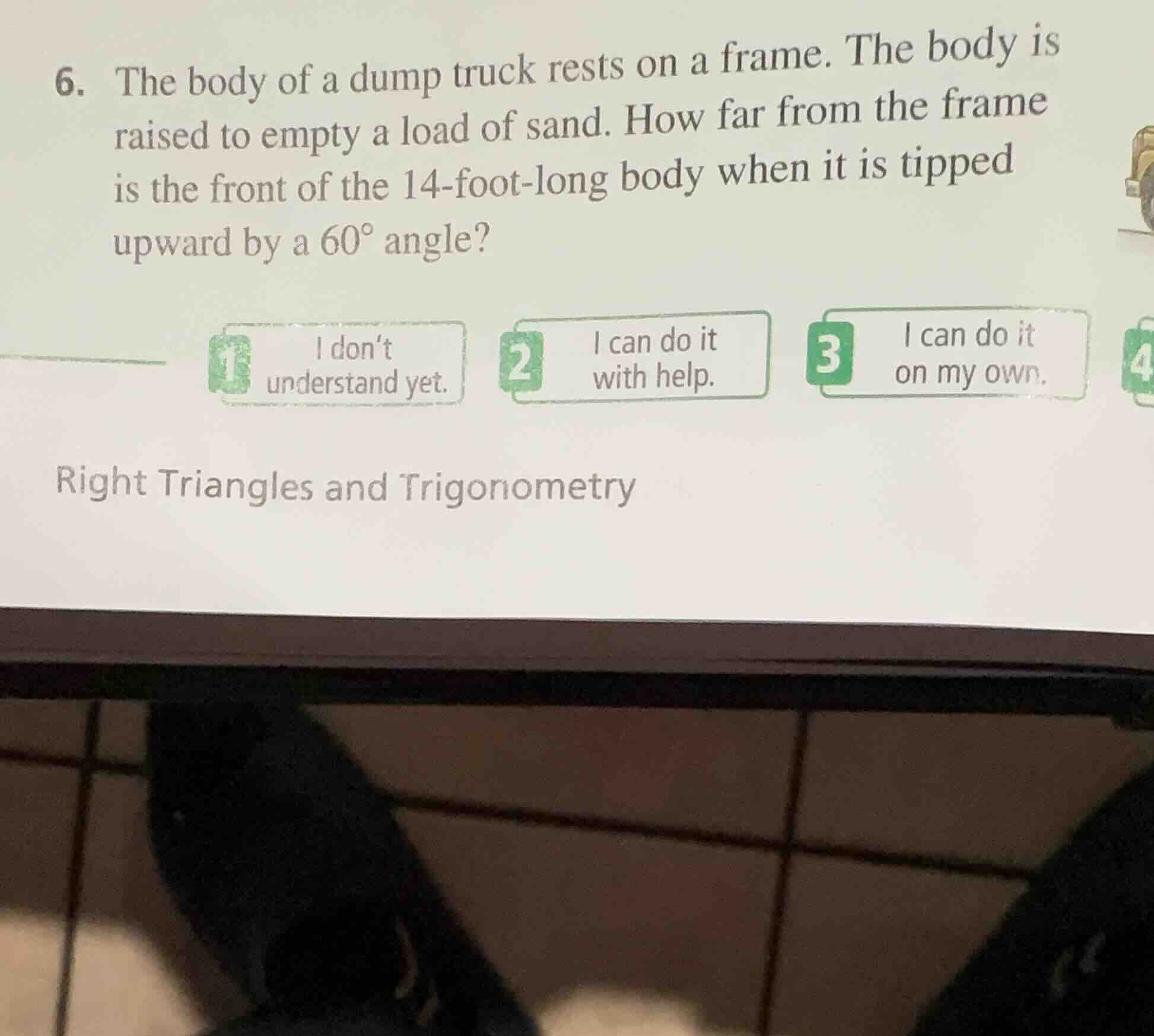 6. the body of a dump truck rests on a frame. the body is raised to emp…