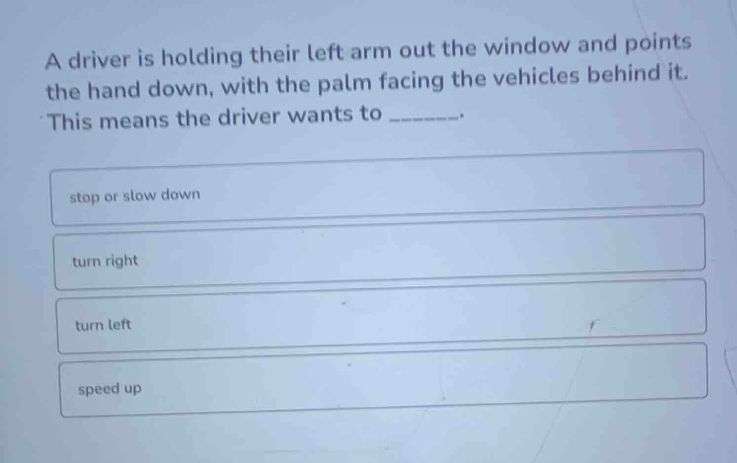 a driver is holding their left arm out the window and points the hand d…